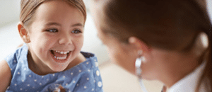 child smiling at doctor